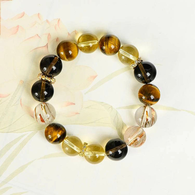 Citrine bracelet with smoky quartz, tiger’s eye, and gold charms by Roline Crystal
