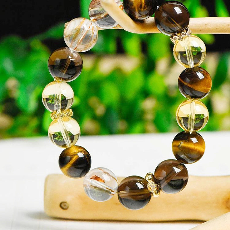 Citrine bracelet with smoky quartz, tiger’s eye, and gold charms by Roline Crystal