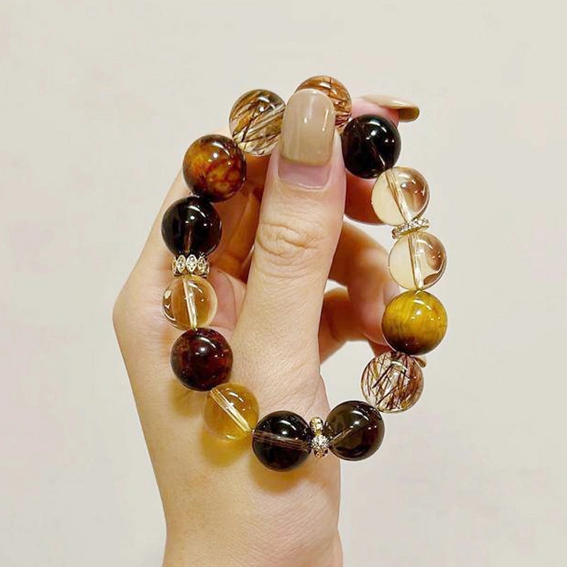 Citrine bracelet with smoky quartz, tiger’s eye, and gold charms by Roline Crystal
