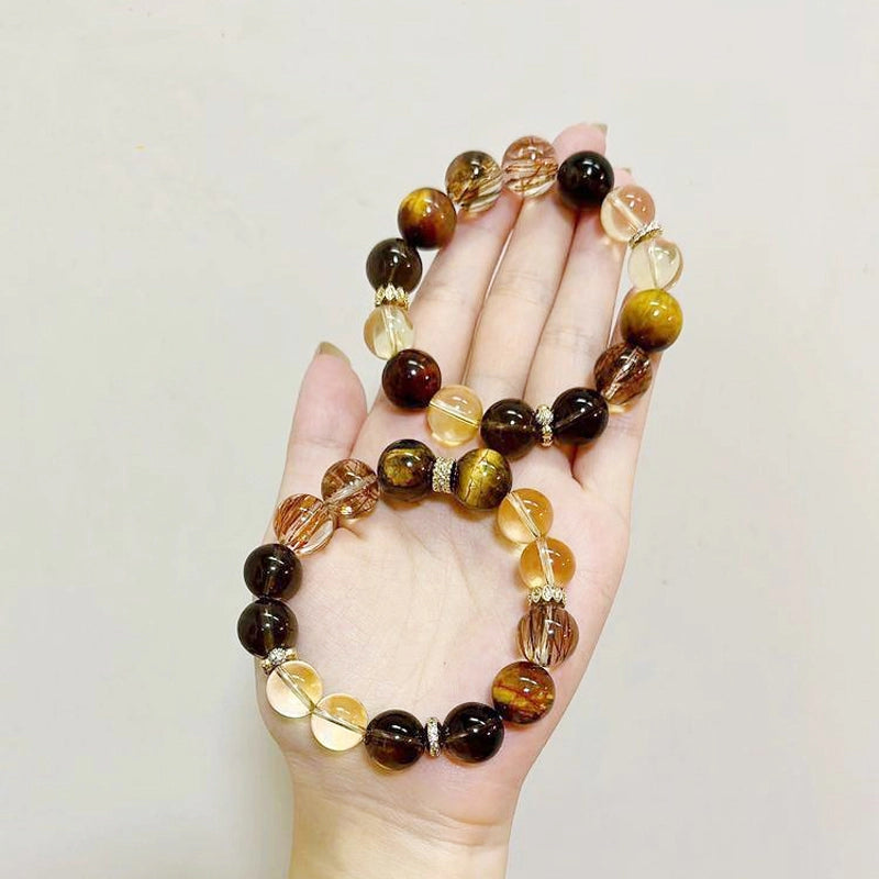 Citrine bracelet with smoky quartz, tiger’s eye, and gold charms by Roline Crystal
