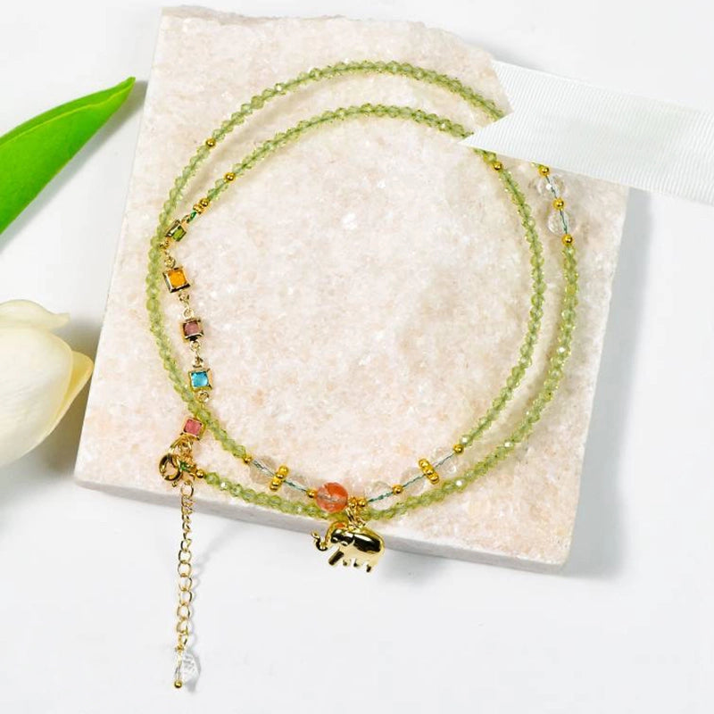 Peridot faceted bracelet with golden elephant charm, convertible to a necklace by Roline Crystal