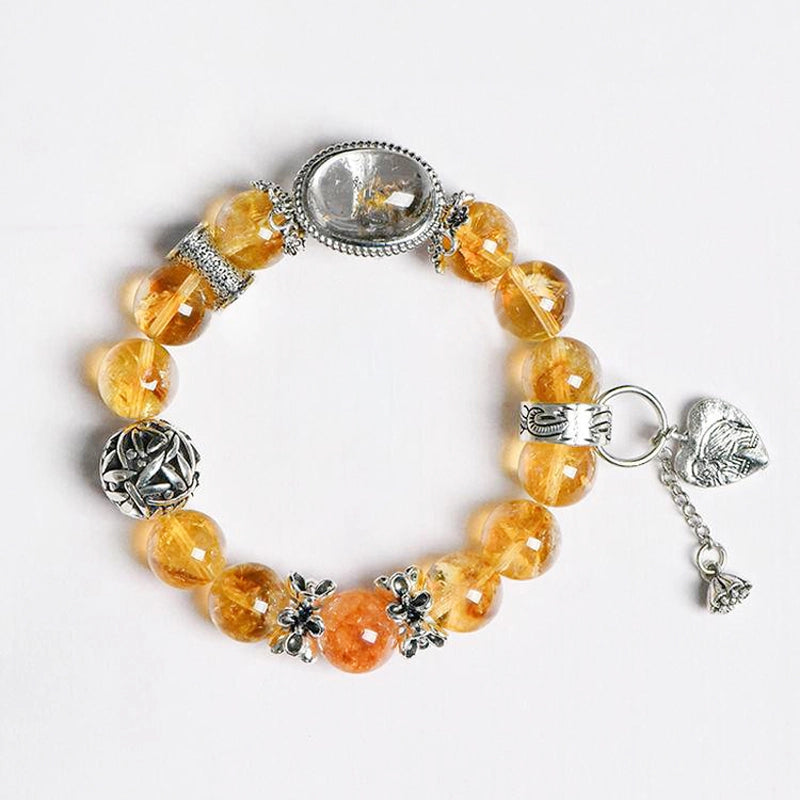 Roline’s Citrine Bracelet blends Citrine, Red Hematoid Quartz & silver accents for abundance & strength. 12mm beads. Shop mystical crystal jewelry now!