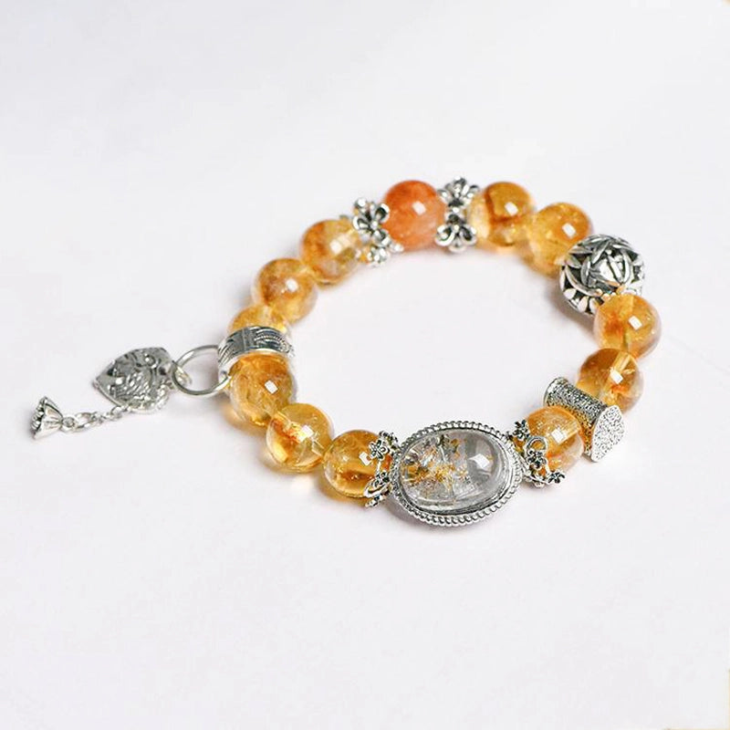 Roline’s Citrine Bracelet blends Citrine, Red Hematoid Quartz & silver accents for abundance & strength. 12mm beads. Shop mystical crystal jewelry now!