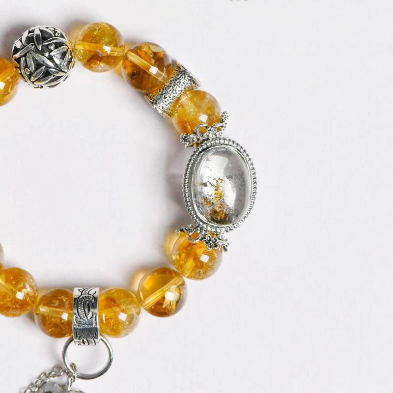 Roline’s Citrine Bracelet blends Citrine, Red Hematoid Quartz & silver accents for abundance & strength. 12mm beads. Shop mystical crystal jewelry now!