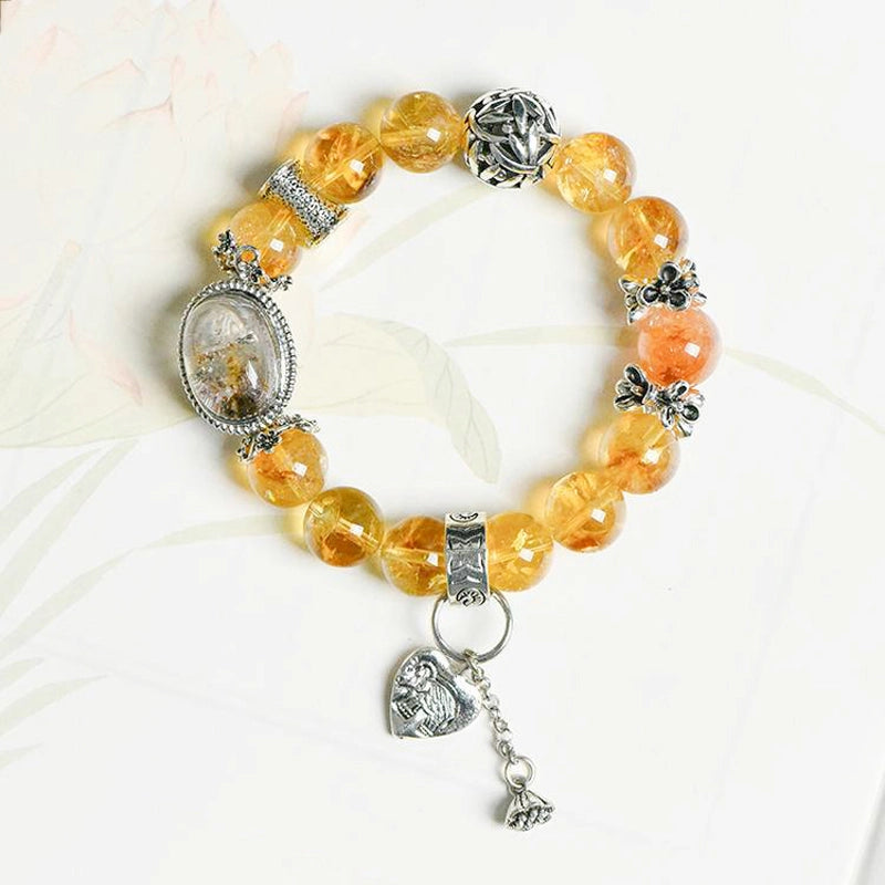 Roline’s Citrine Bracelet blends Citrine, Red Hematoid Quartz & silver accents for abundance & strength. 12mm beads. Shop mystical crystal jewelry now!