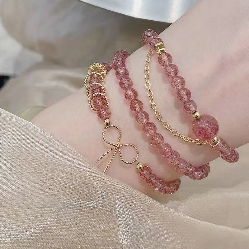 Strawberry crystal multi-ring bracelet with golden bow and chain accents by Roline Crystal