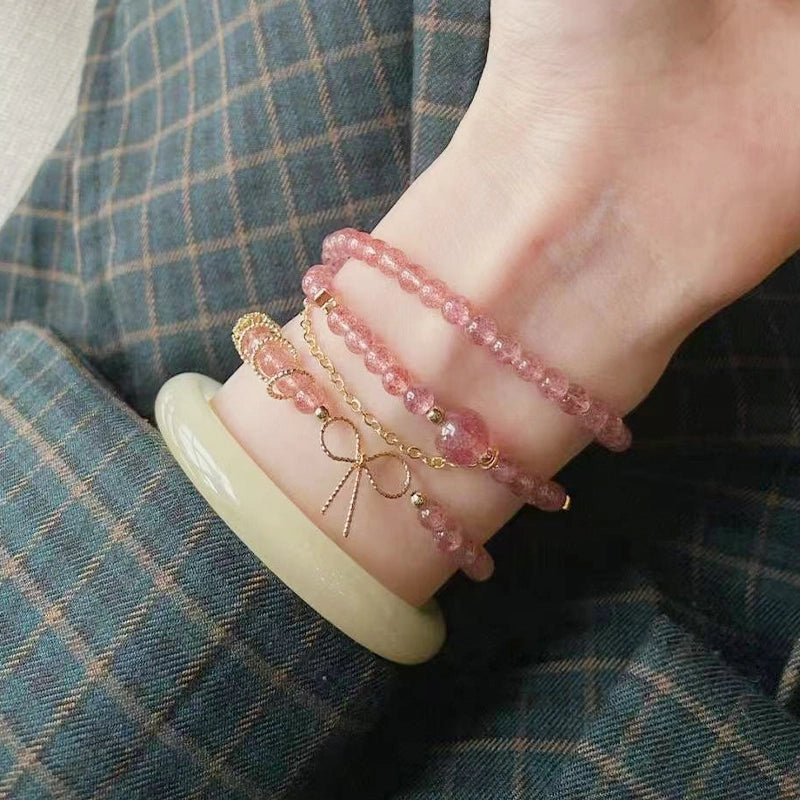 Strawberry crystal multi-ring bracelet with golden bow and chain accents by Roline Crystal