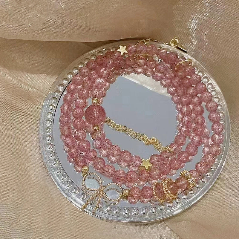 Strawberry crystal multi-ring bracelet with golden bow and chain accents by Roline Crystal