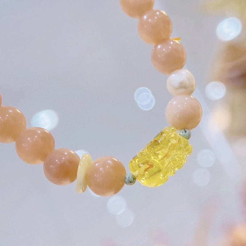 Sunstone bracelet with Amber Pixiu charm and golden beads by Roline Crystal