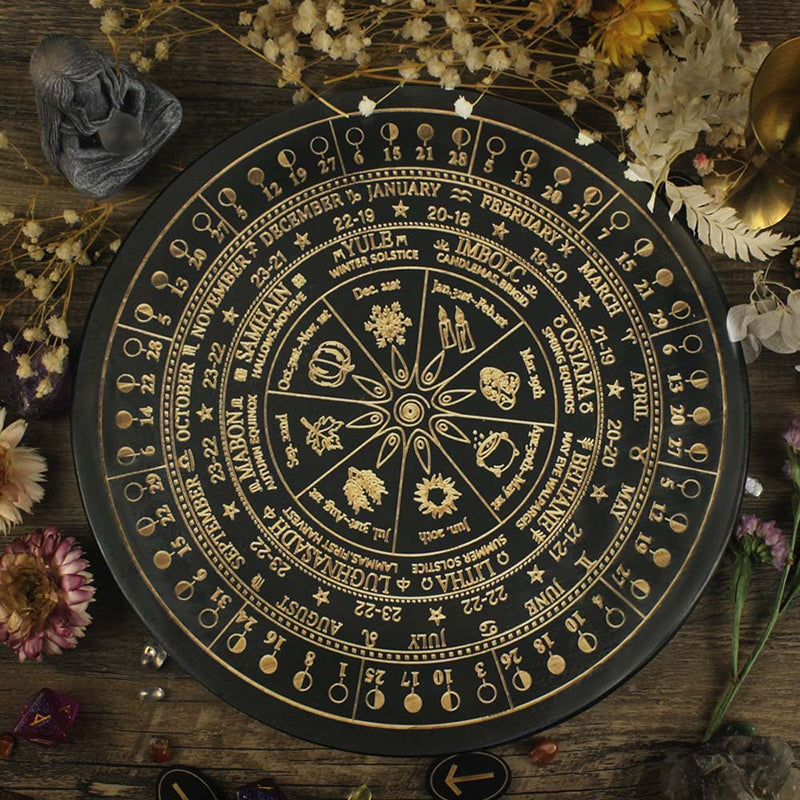 The ritual tools of the witch: wooden carved altar astrolabe, moon phase calendar prayer ritual wheel