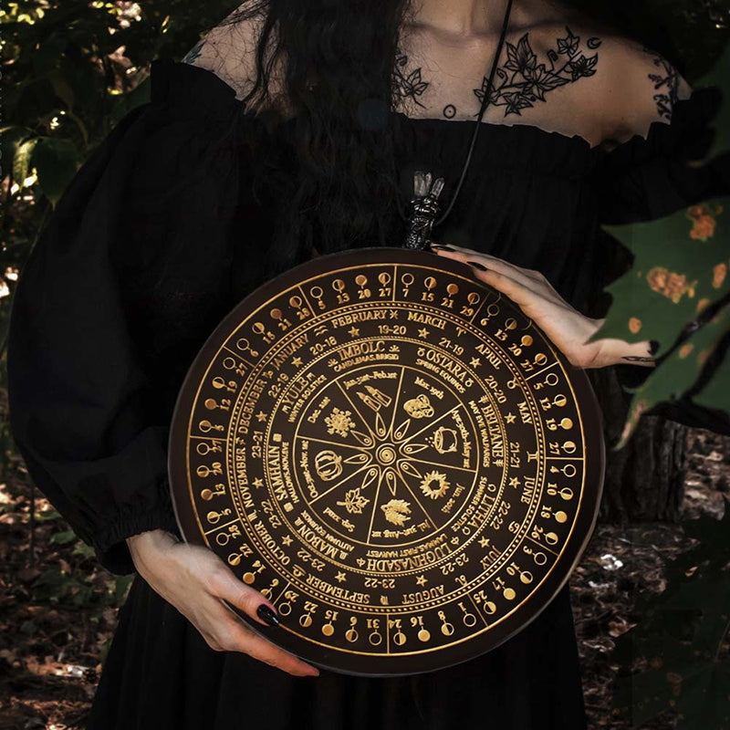 The ritual tools of the witch: wooden carved altar astrolabe, moon phase calendar prayer ritual wheel