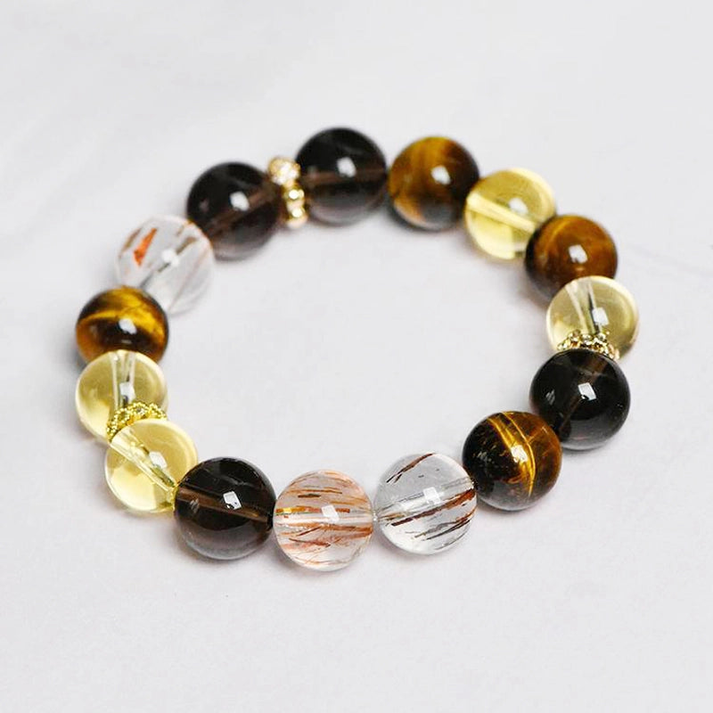Citrine bracelet with smoky quartz, tiger’s eye, and gold charms by Roline Crystal