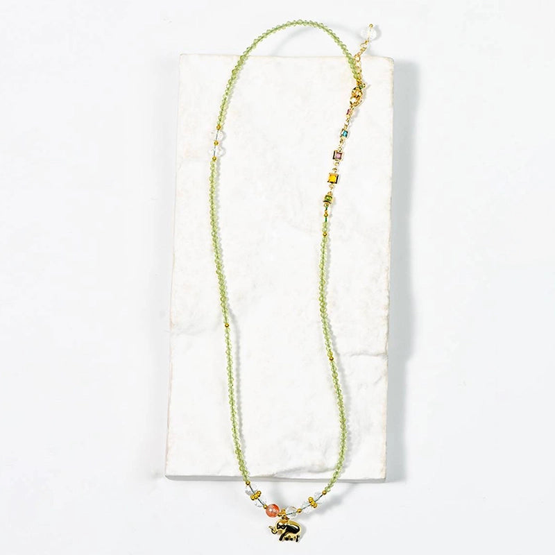 Peridot faceted bracelet with golden elephant charm, convertible to a necklace by Roline Crystal