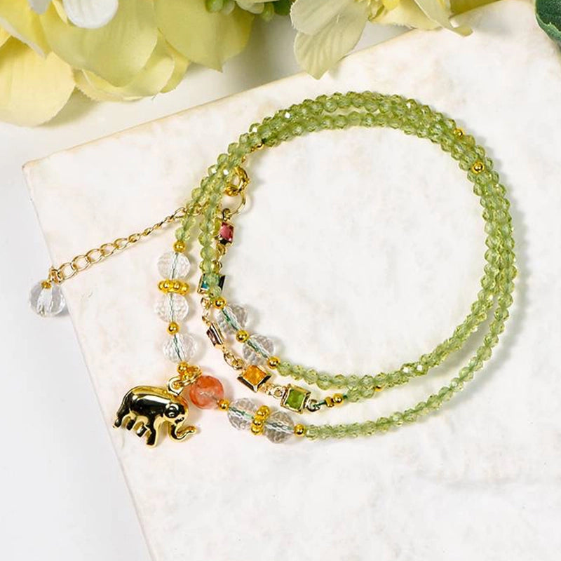 Peridot faceted bracelet with golden elephant charm, convertible to a necklace by Roline Crystal