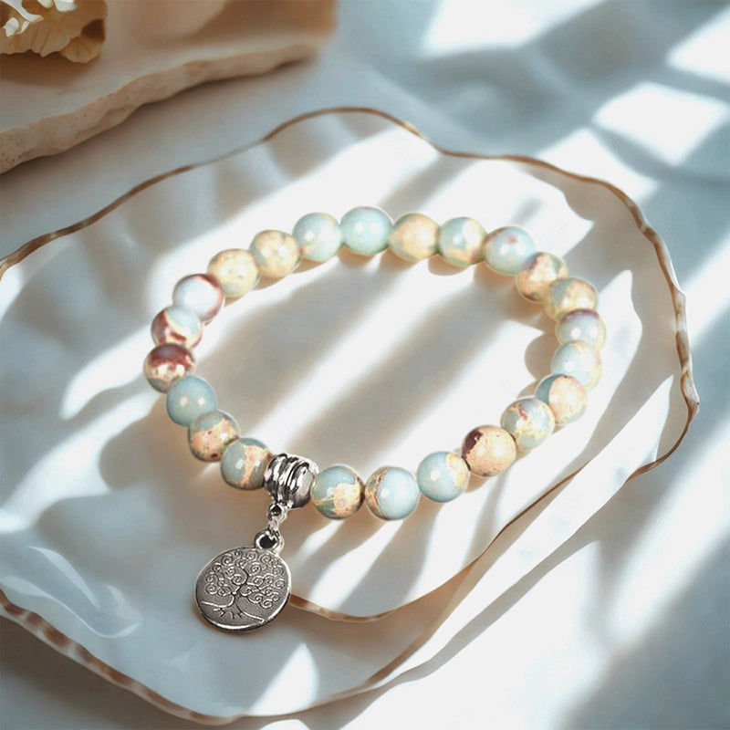 Snakeskin stone bracelet with Horus Eye, owl, lion, and symbolic charms by Roline Crystal