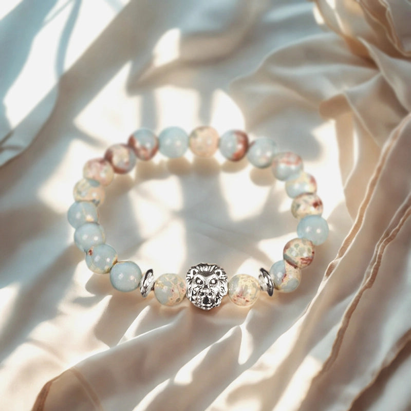 Snakeskin stone bracelet with Horus Eye, owl, lion, and symbolic charms by Roline Crystal
