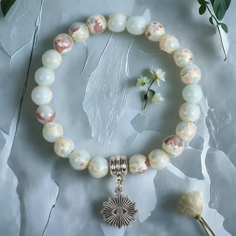Snakeskin stone bracelet with Horus Eye, owl, lion, and symbolic charms by Roline Crystal